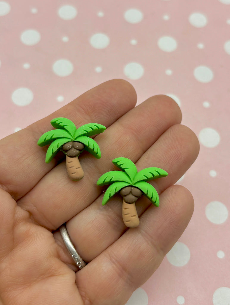 a person holding two small palm trees in their hand