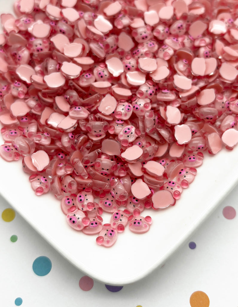 a white plate topped with lots of pink beads