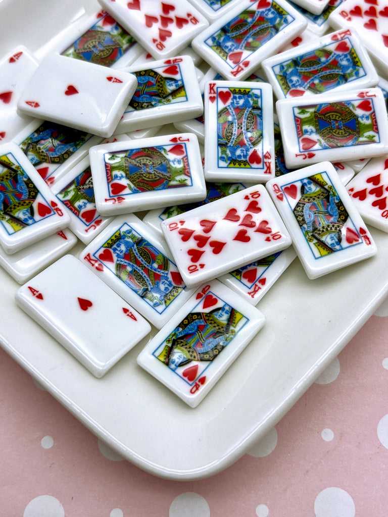 a white plate topped with lots of playing cards