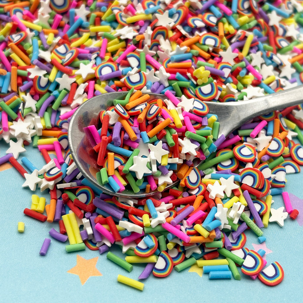 a spoon full of colorful sprinkles on a blue surface