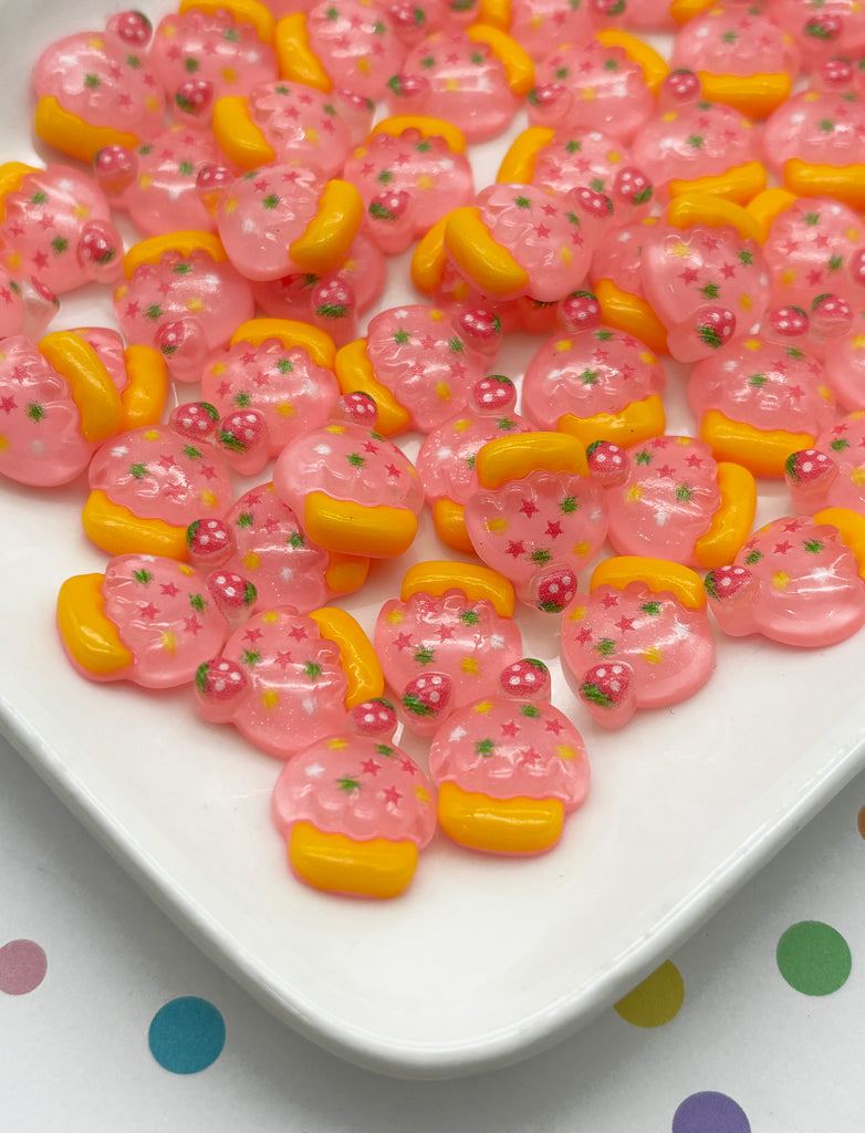 a white plate topped with lots of pink and yellow donuts