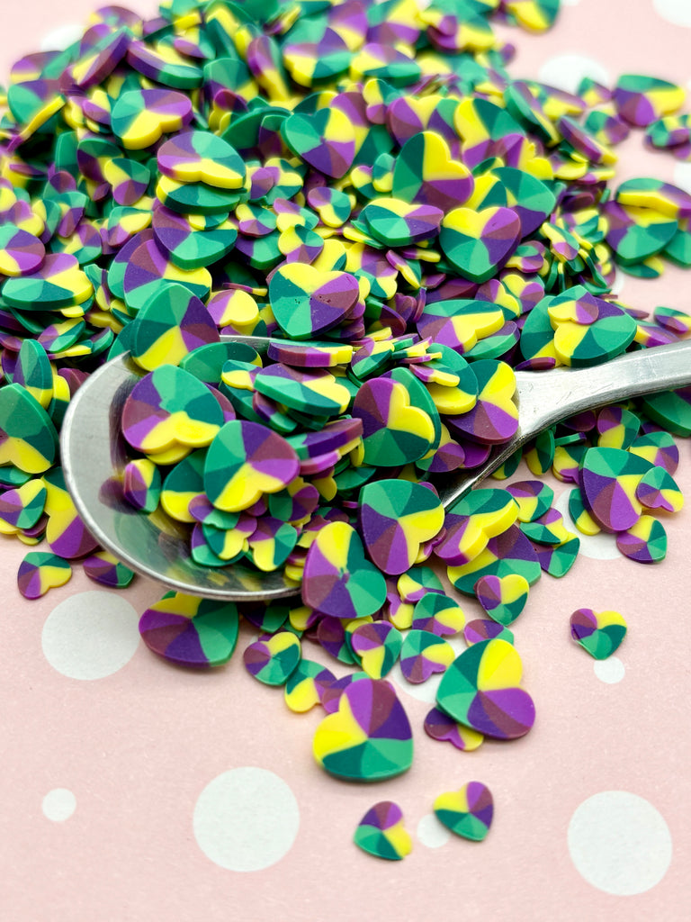 a spoon full of confetti sitting on a table