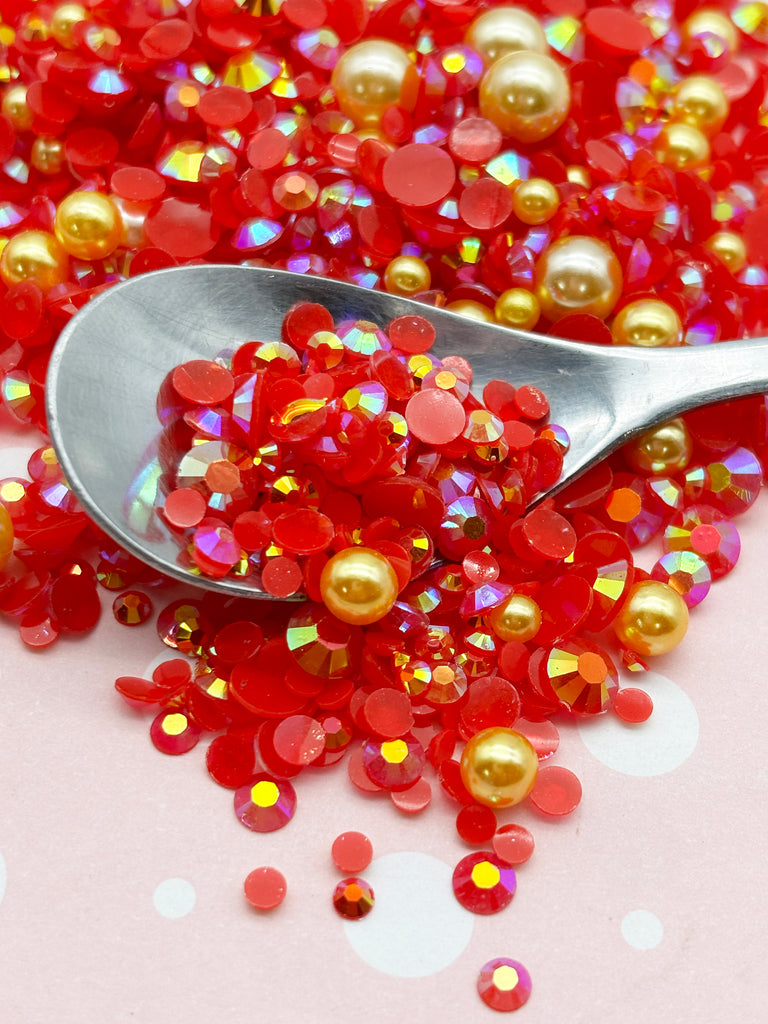 a spoon full of red and gold sprinkles