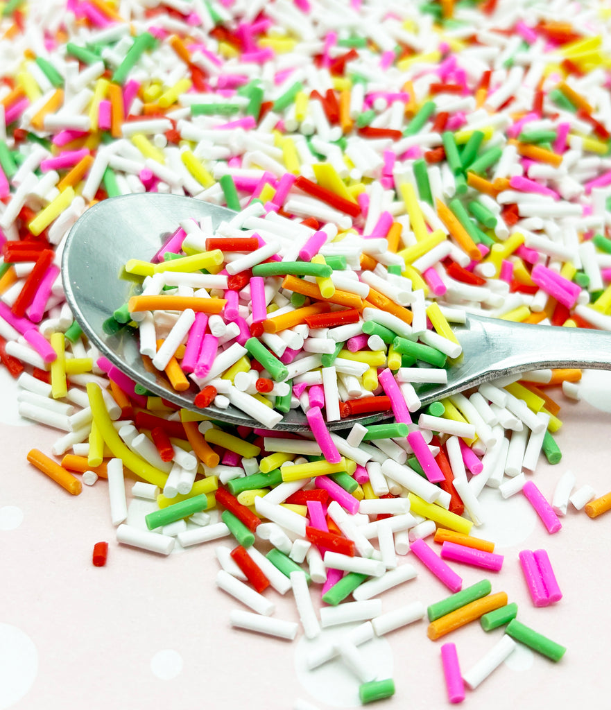a spoon full of sprinkles on a table