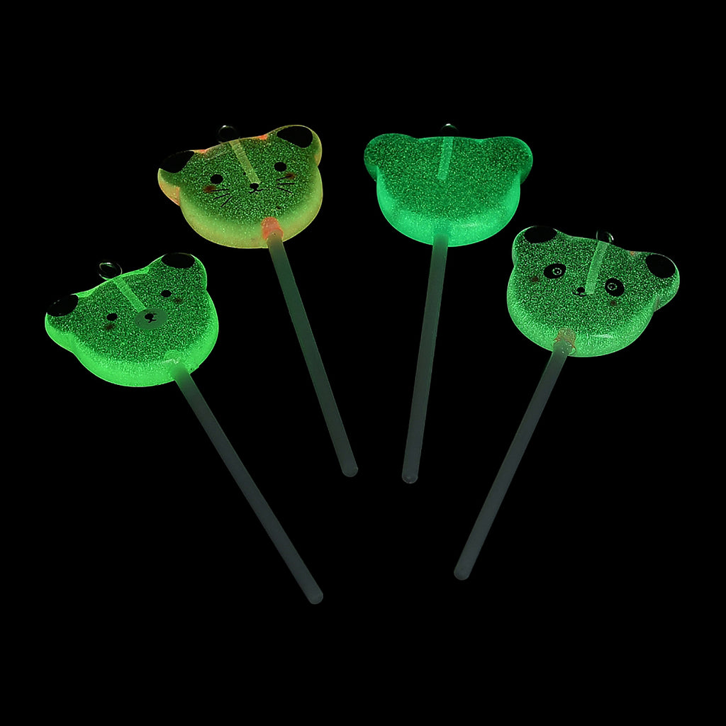 a group of four green flowers on a black background
