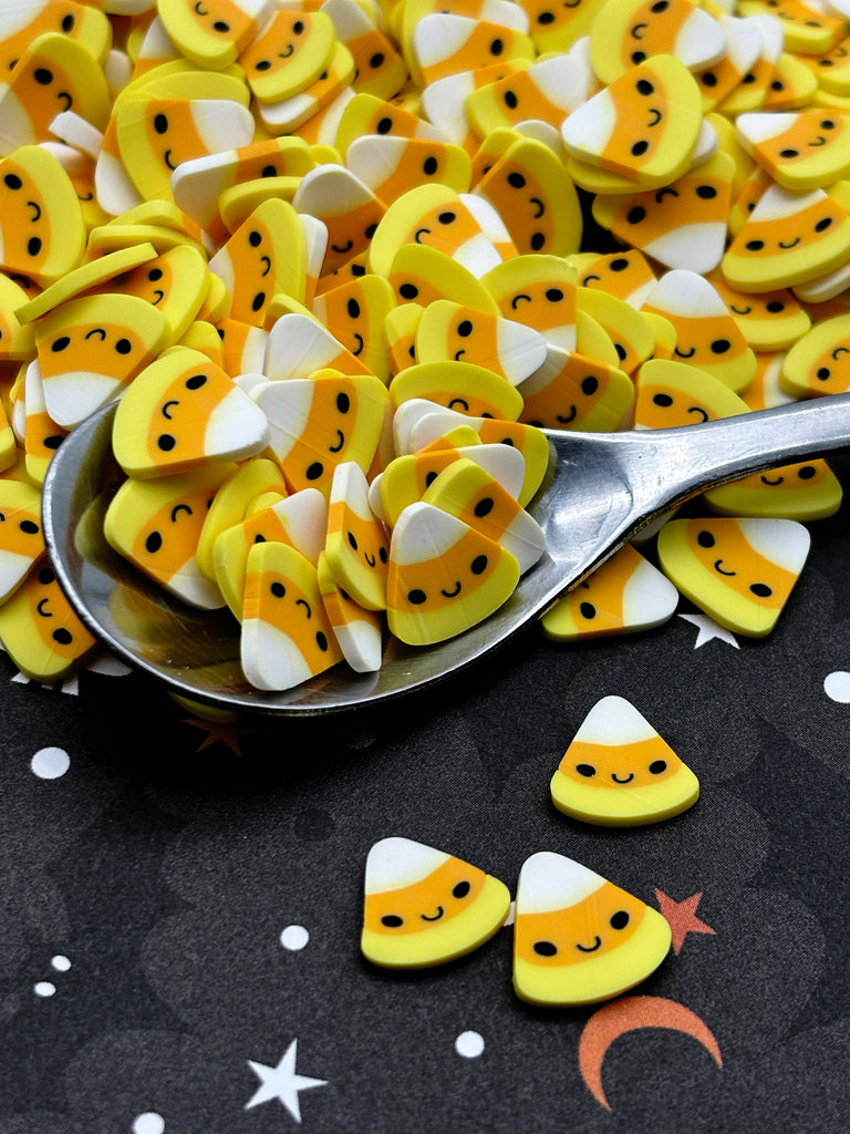a spoon full of yellow and white buttons
