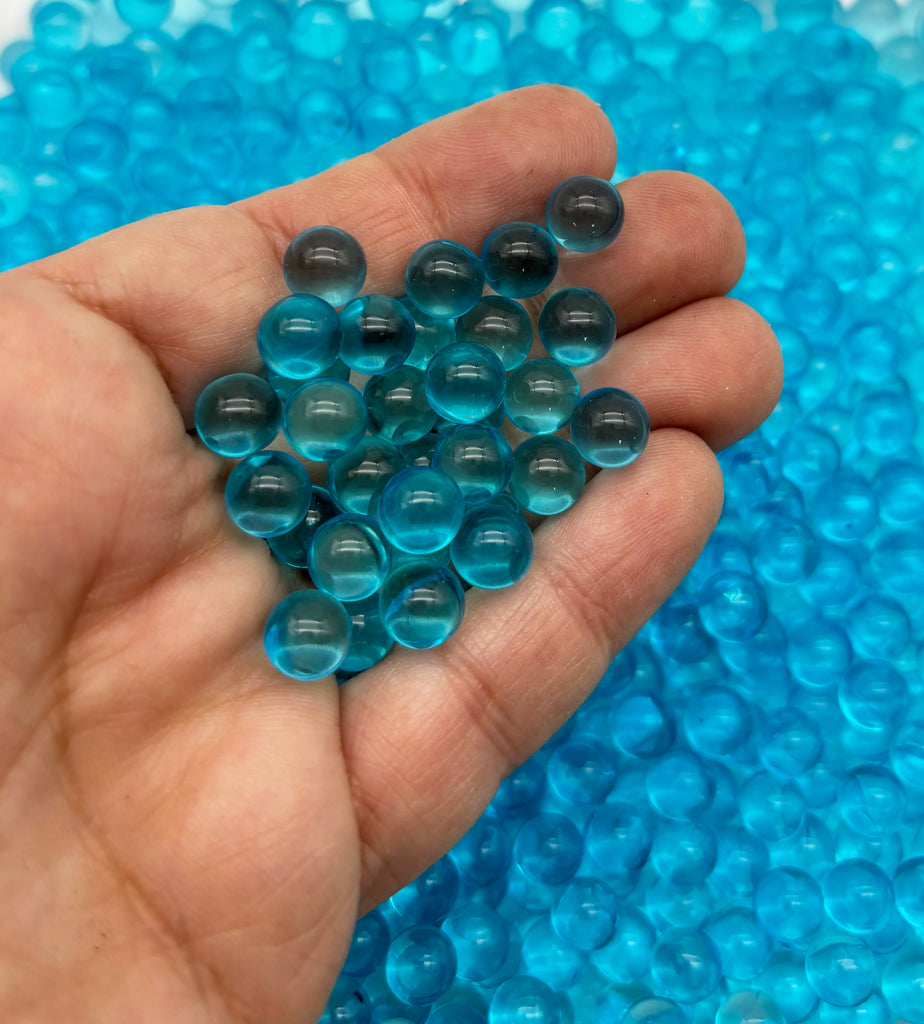 a hand holding a bunch of blue beads