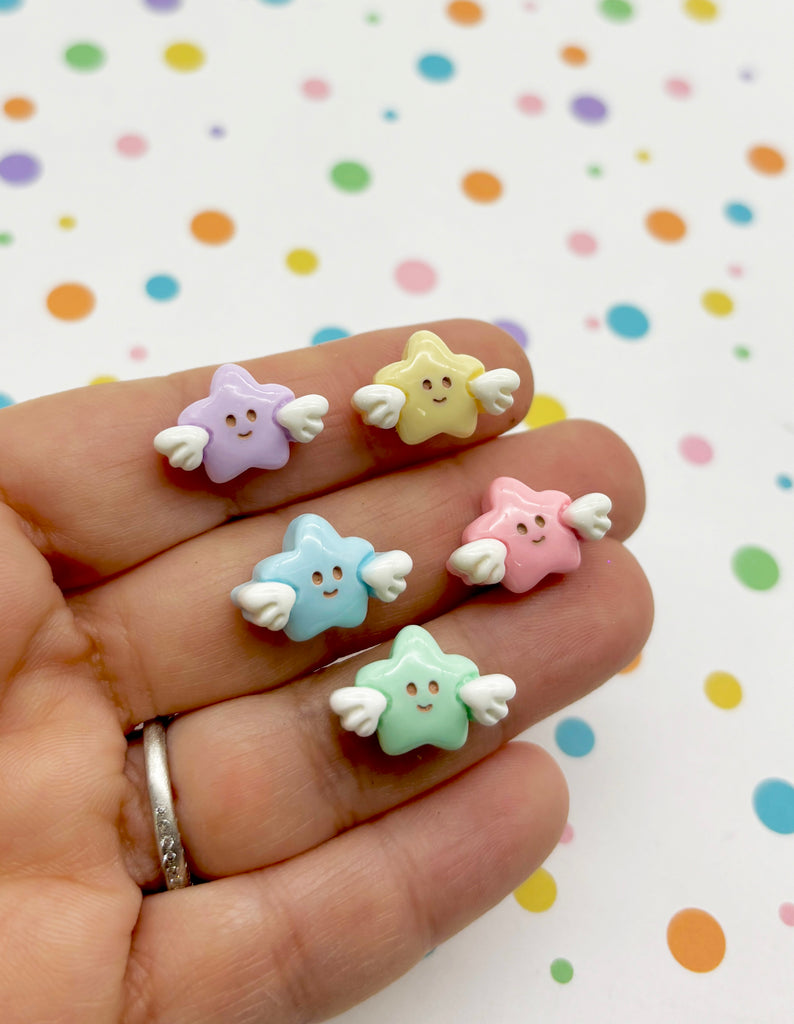 a person's hand holding four small toy animals