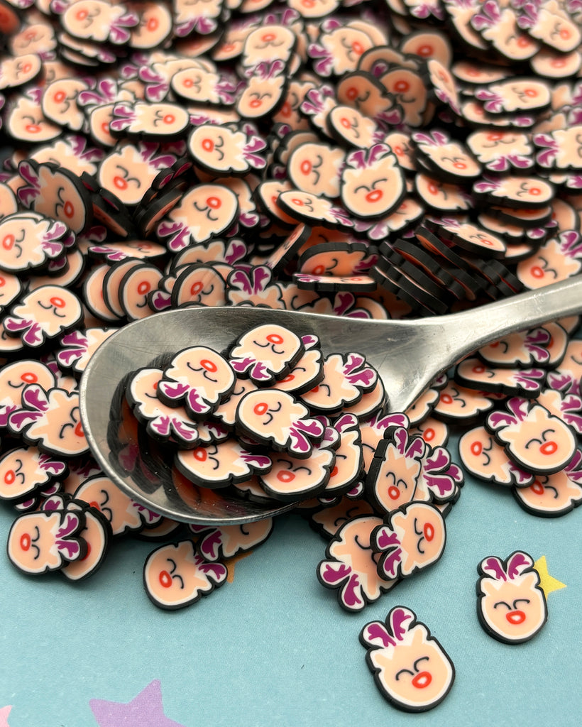 a pile of buttons with a spoon on top of them