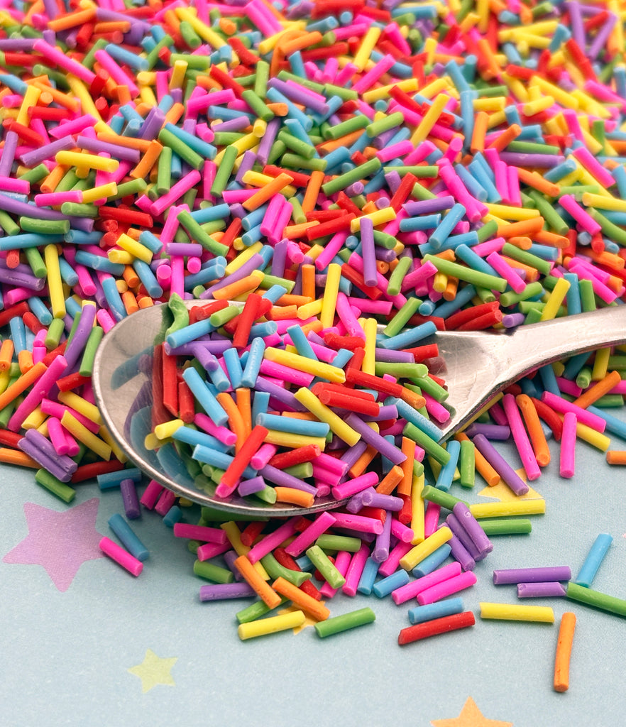 a spoon full of sprinkles on a table