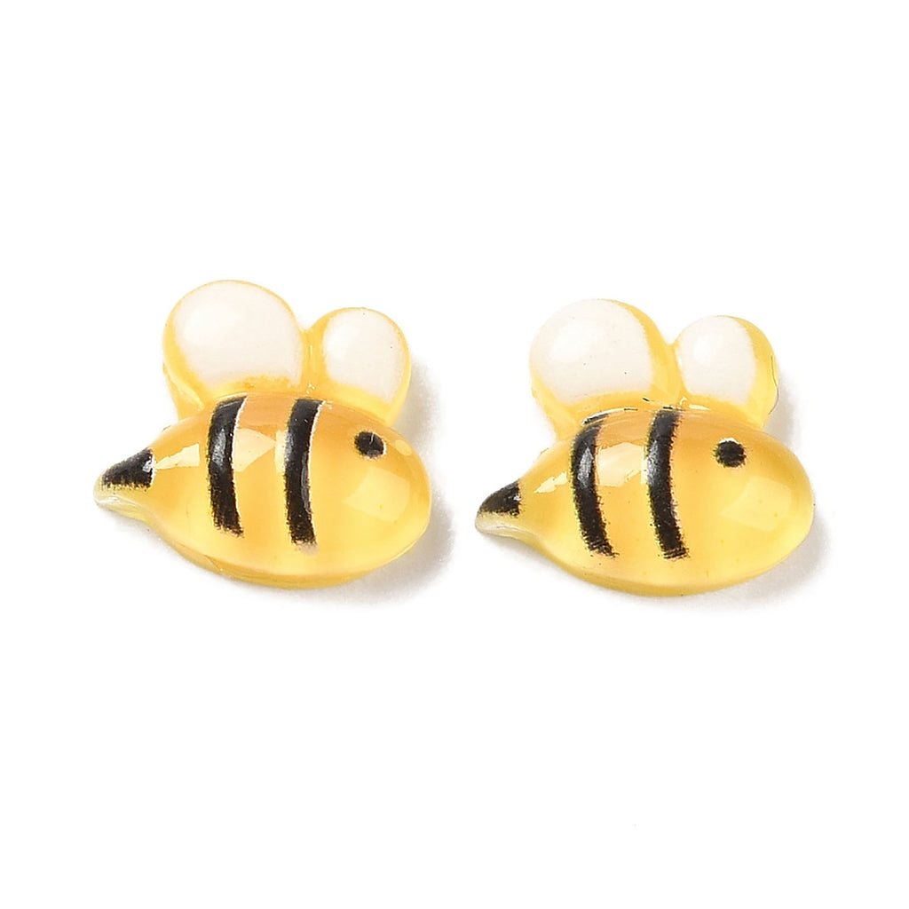 a pair of yellow and black fish earrings