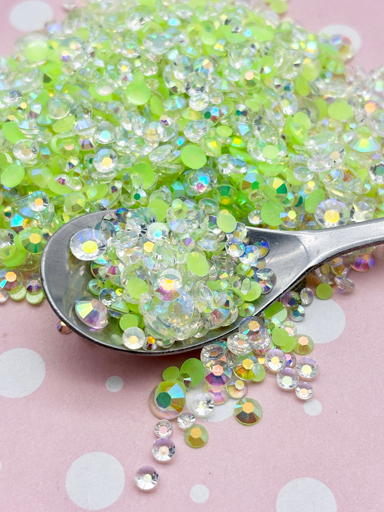 a spoon full of glitter sitting on top of a table