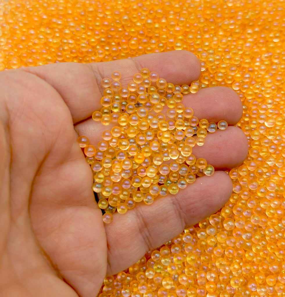 a hand holding a bunch of yellow beads