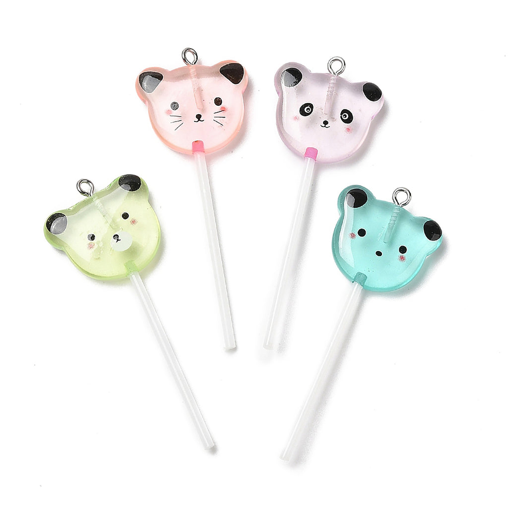 a group of three cat shaped lollipops sitting on top of each other