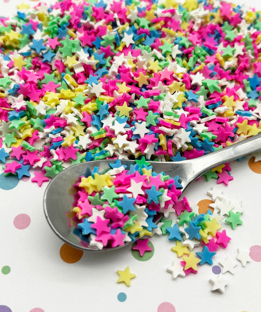 a spoon full of sprinkles on top of a table