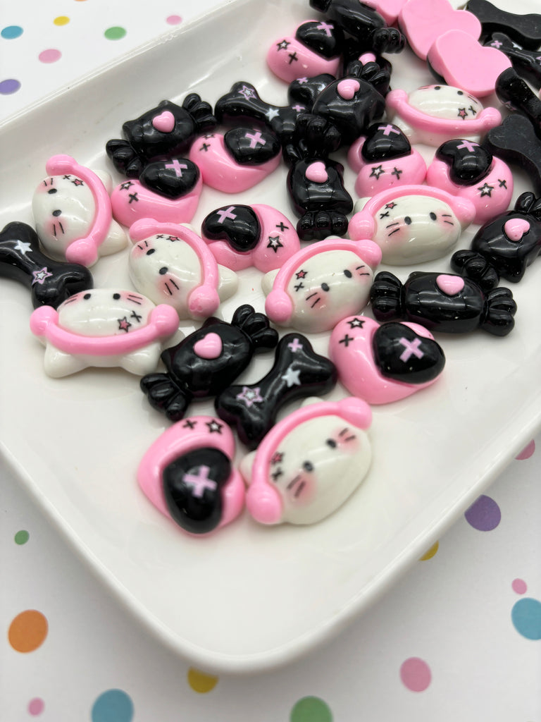 a white plate topped with lots of black and pink teddy bears