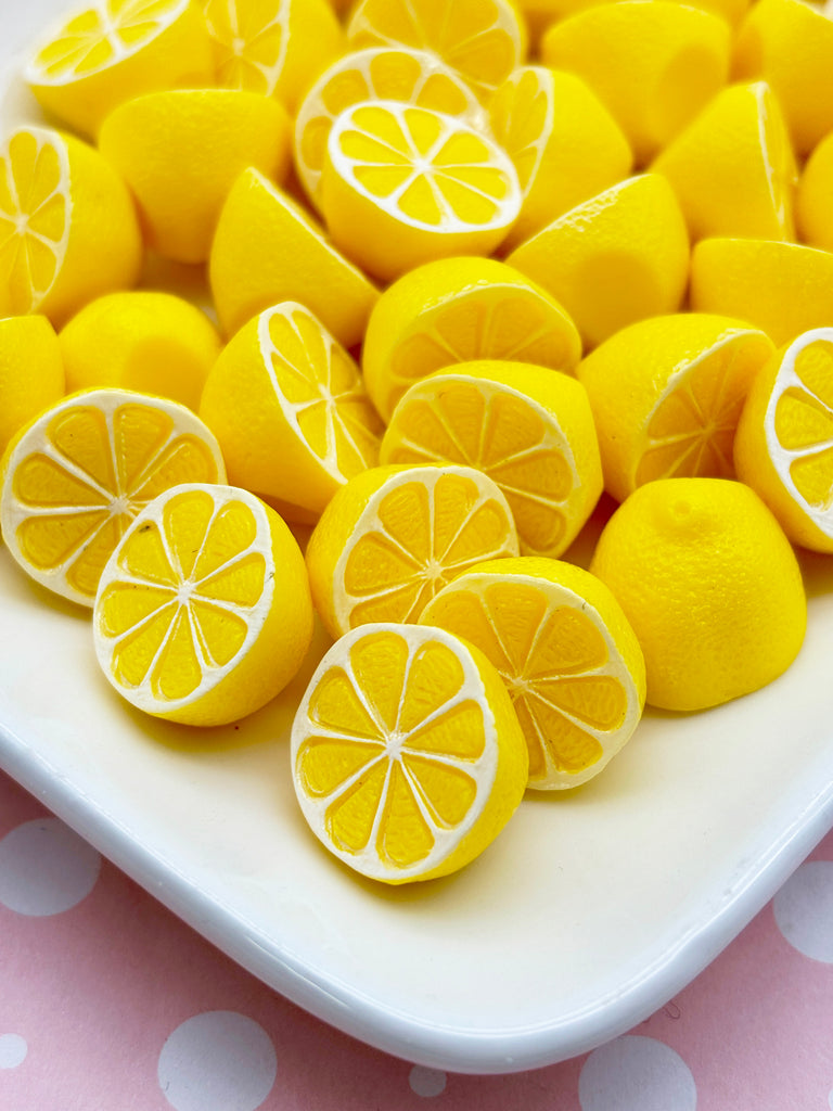 a white plate topped with lemons on top of a table
