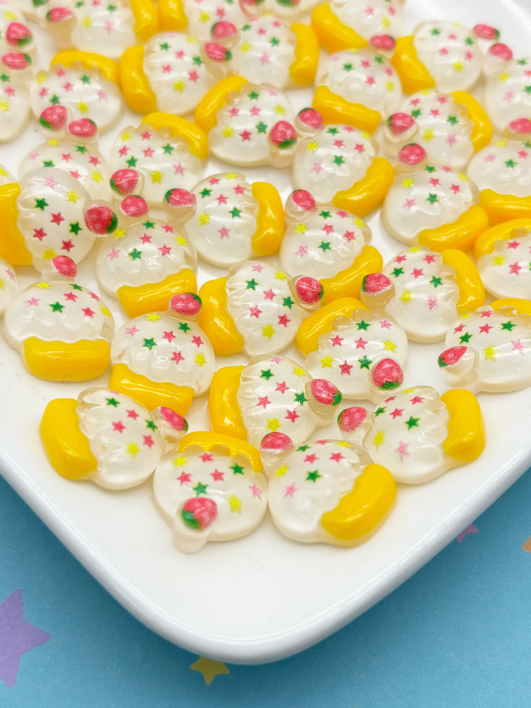 a white plate topped with lots of yellow and white cookies