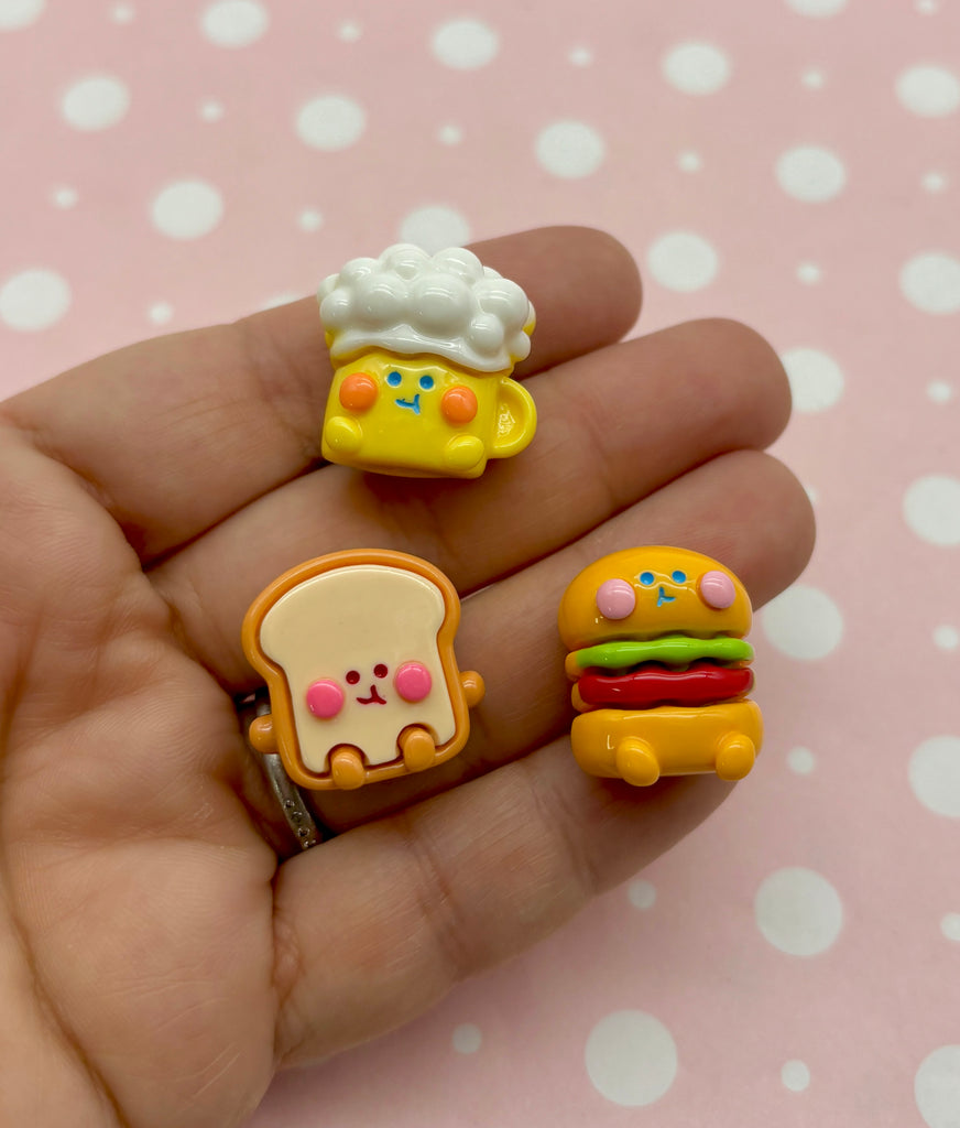 a hand holding three different shaped food items