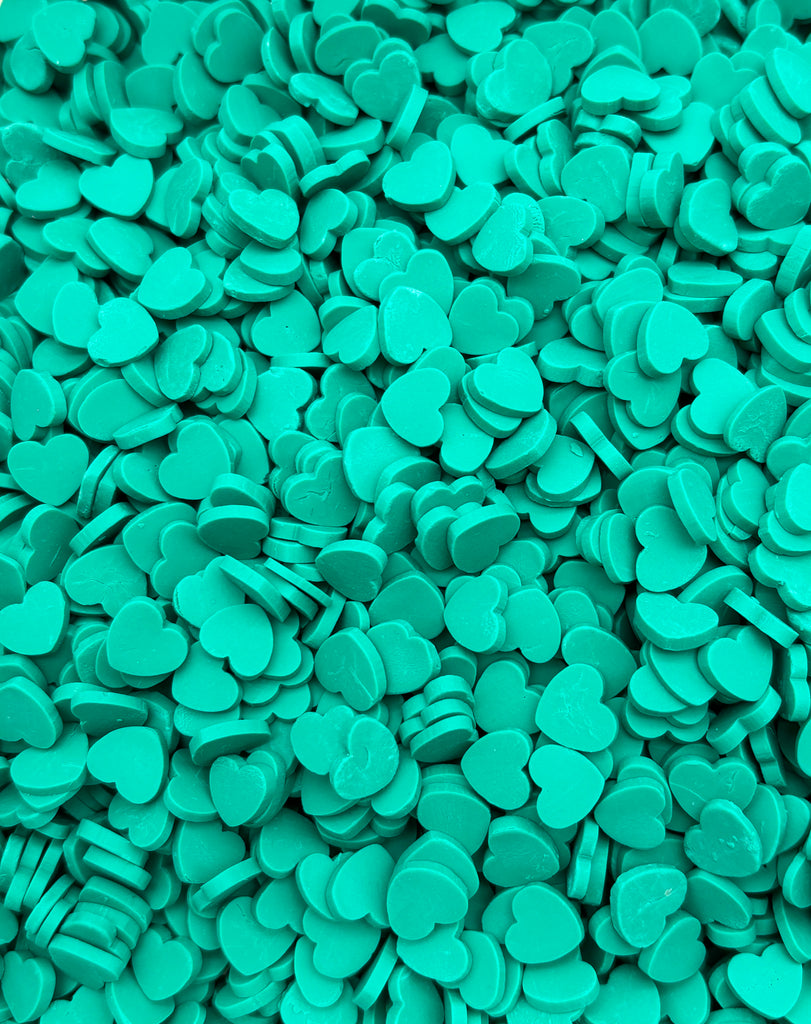 a close up of a pile of green buttons
