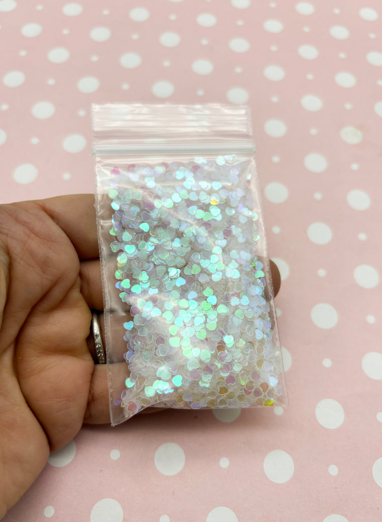 a person holding a bag of glitter in their hand