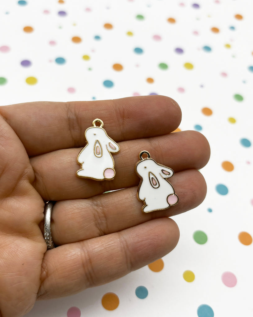 a person holding a pair of bunny shaped earrings