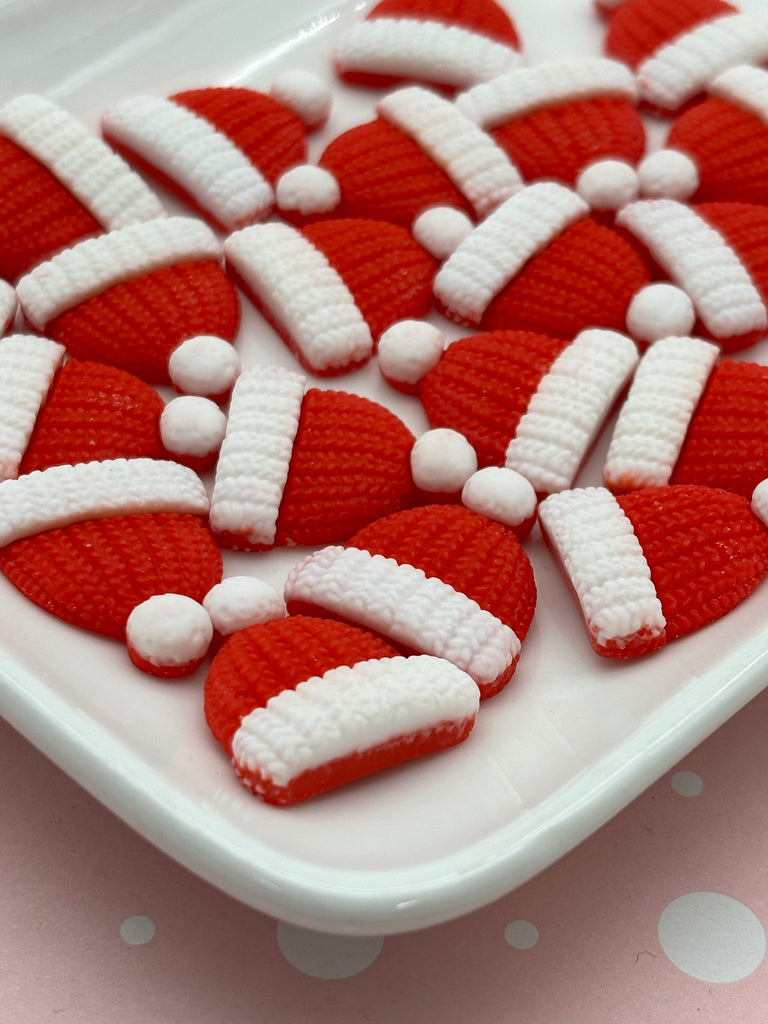 a white plate topped with red and white cookies