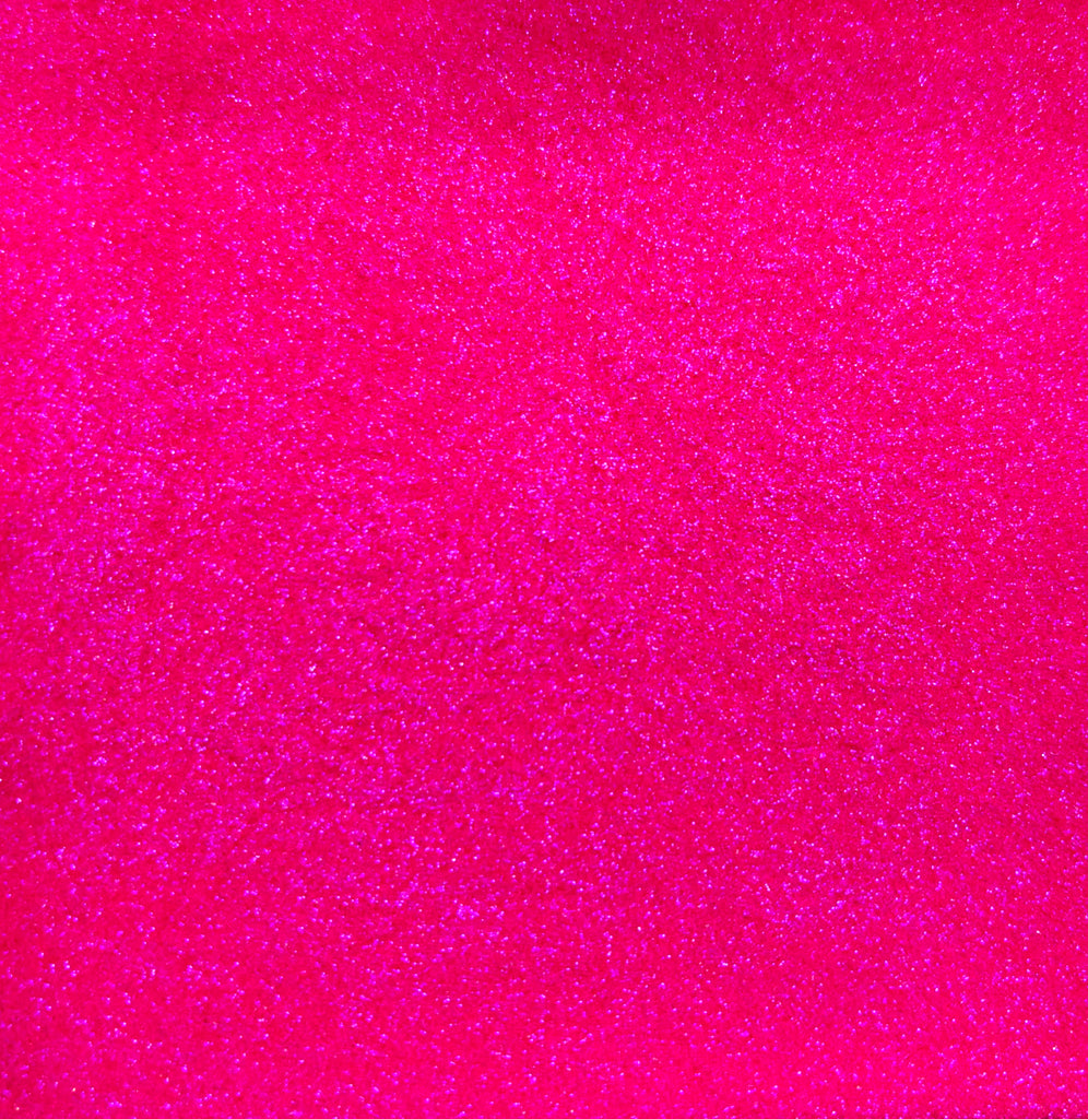 a bright pink background with small speckles