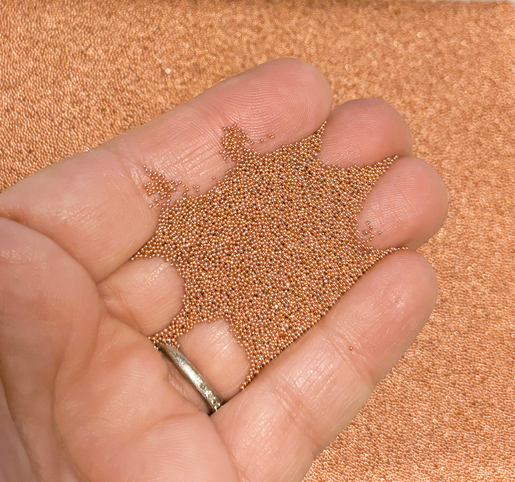 a person holding a handful of grain in their hand