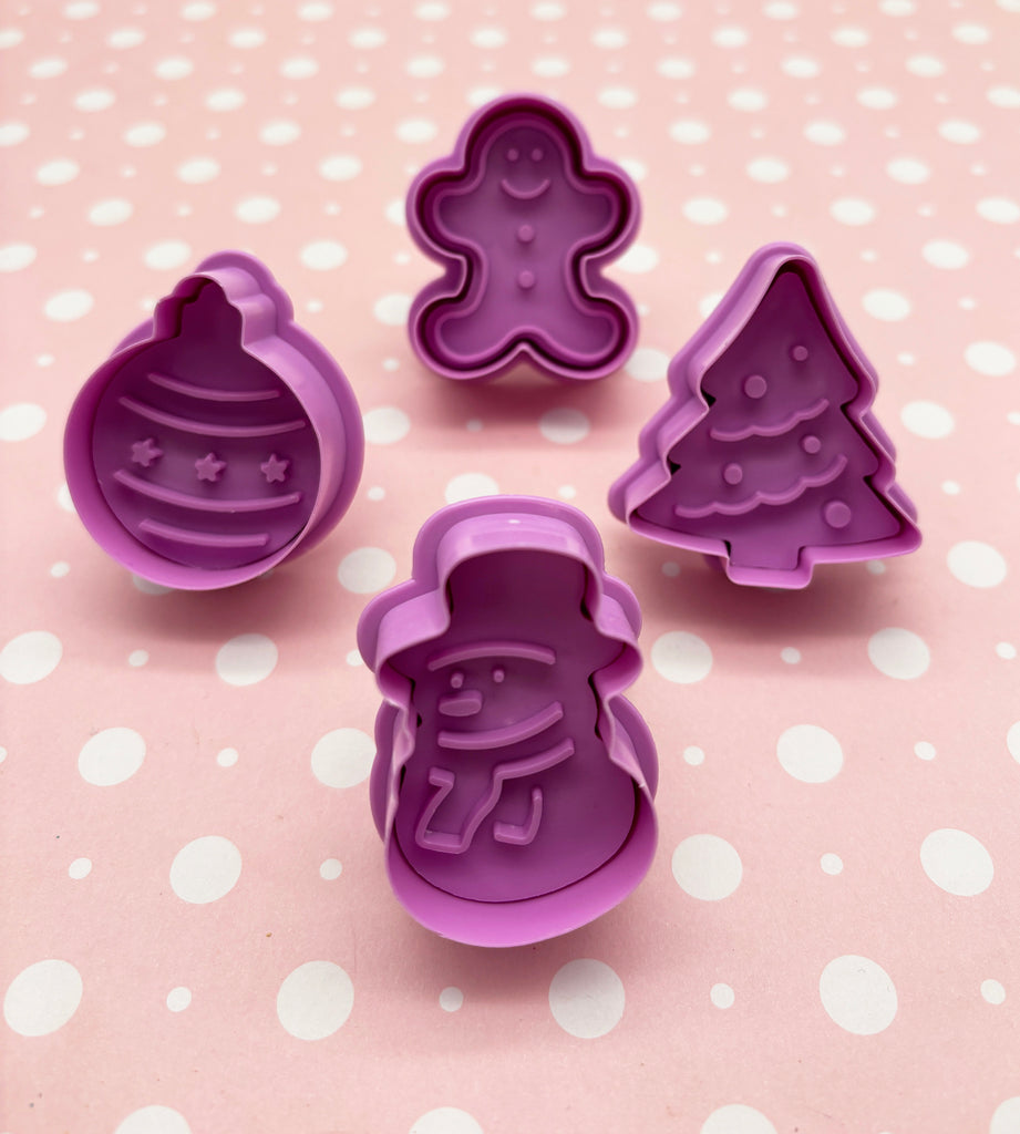 a set of cookie cutters with christmas decorations