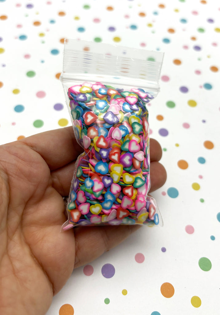 a hand holding a bag of colorful candy