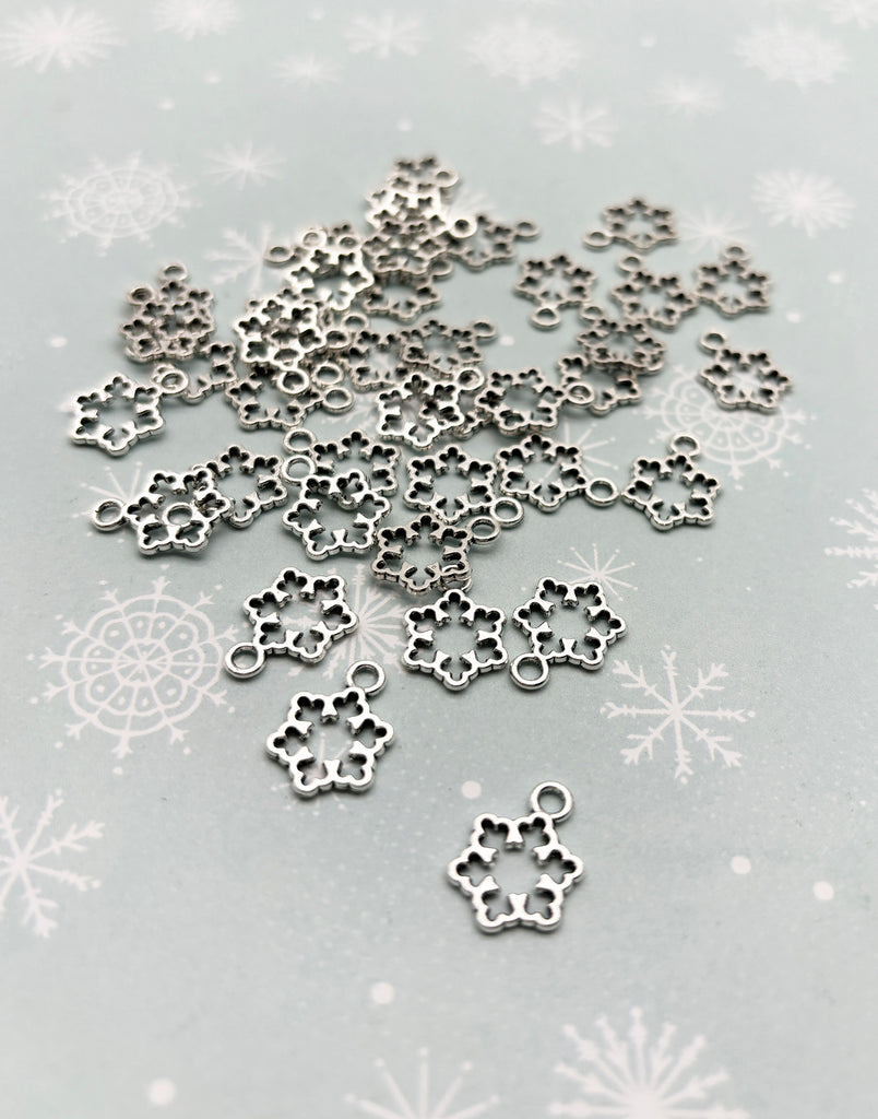 a close up of a snowflake with snowflakes in the background