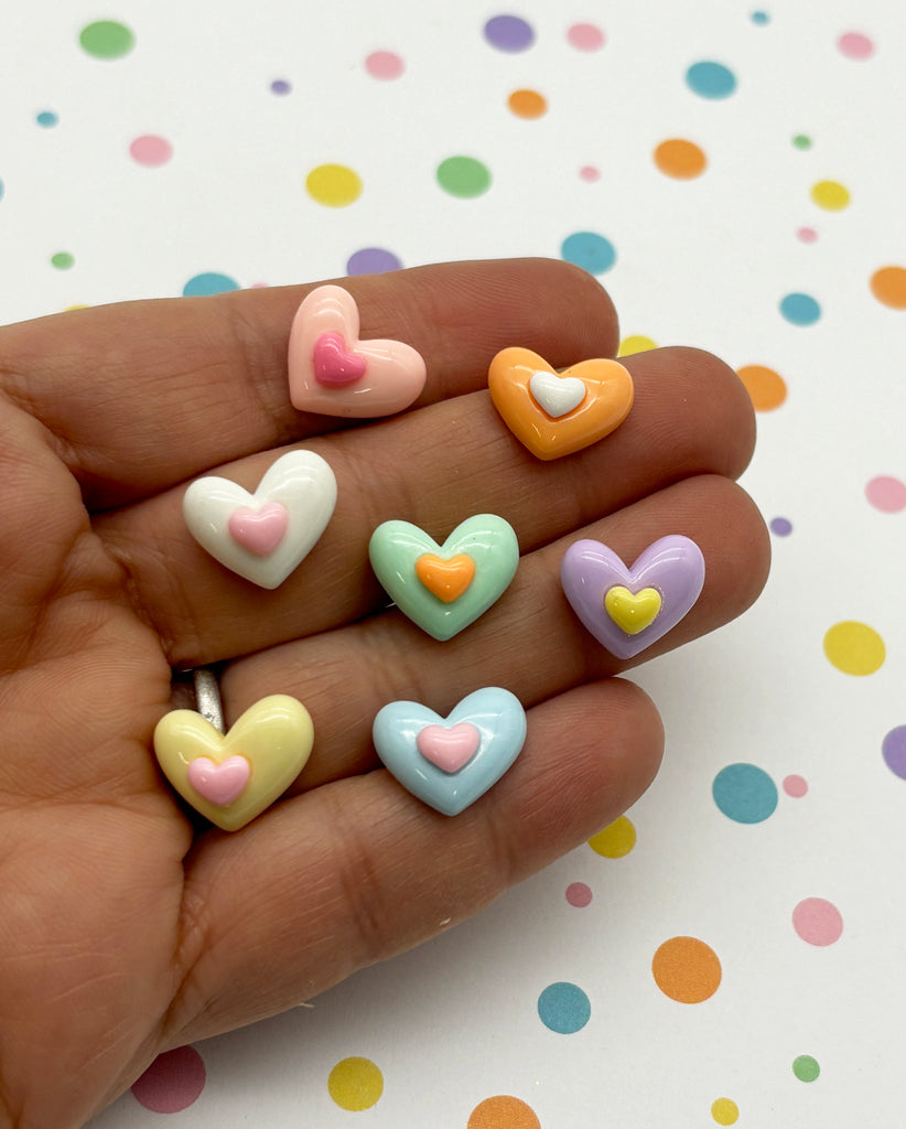 a hand holding a small assortment of hearts