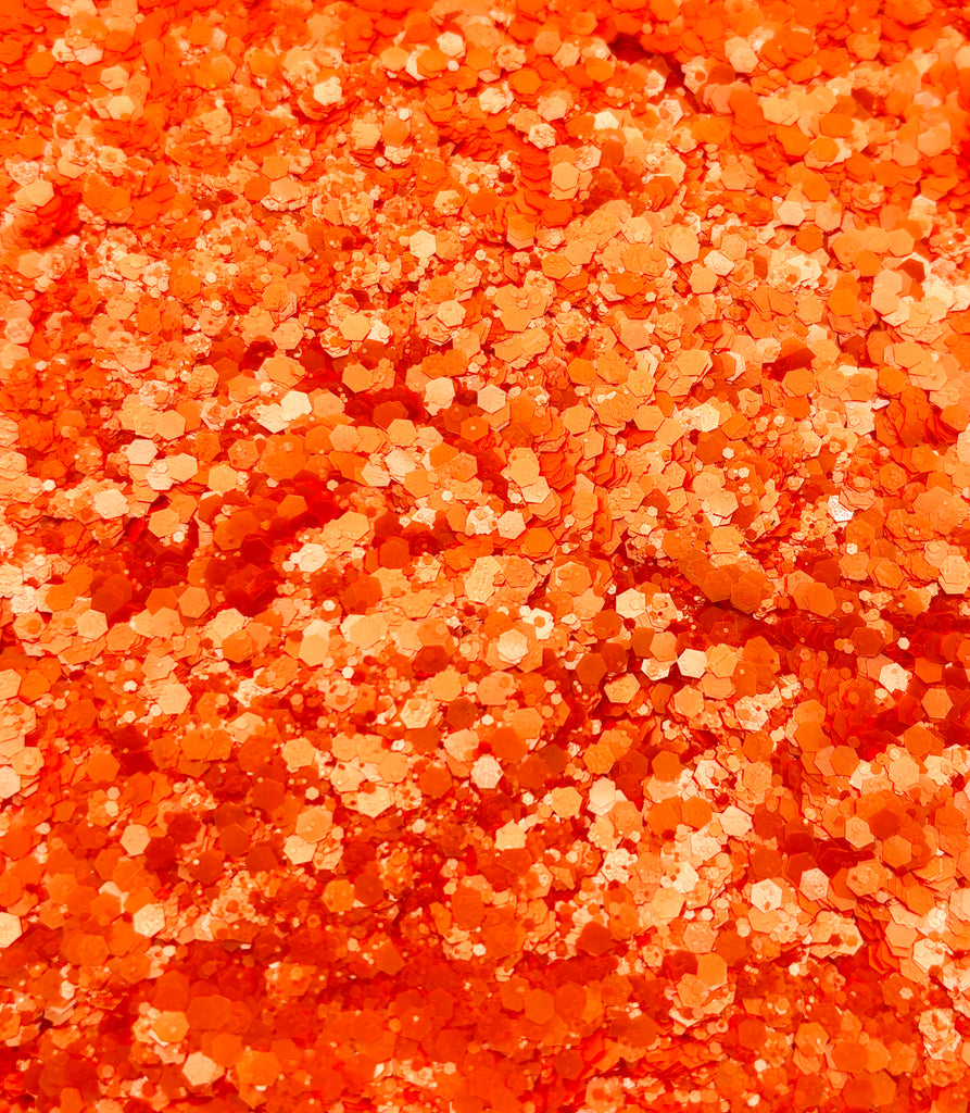 a close up of a red and gold glitter background