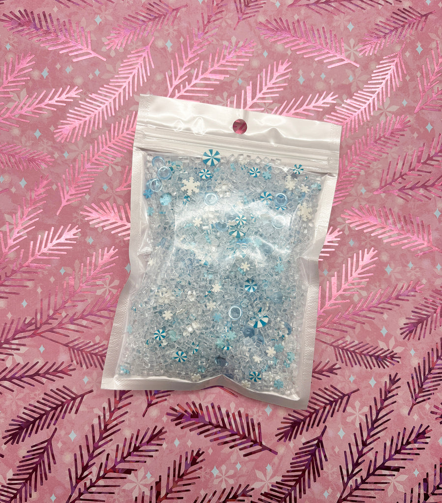 a bag of beads sitting on top of a pink blanket