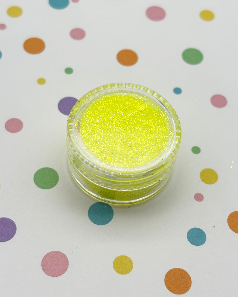 a yellow glitter powder sitting on top of a table