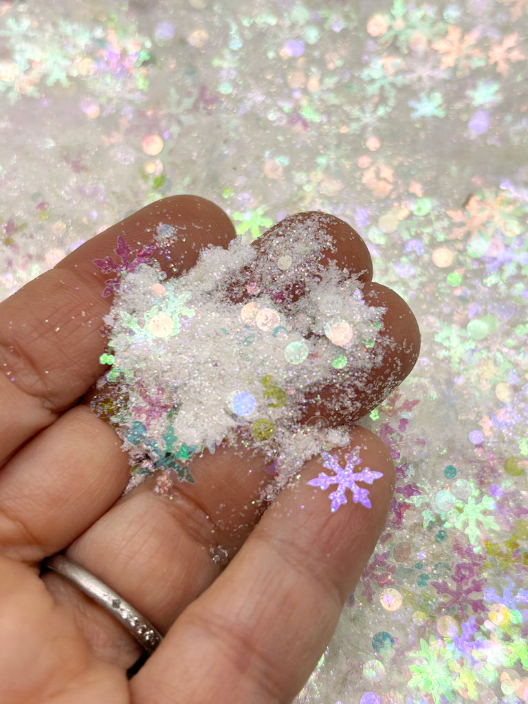 a hand holding a handful of snow flakes