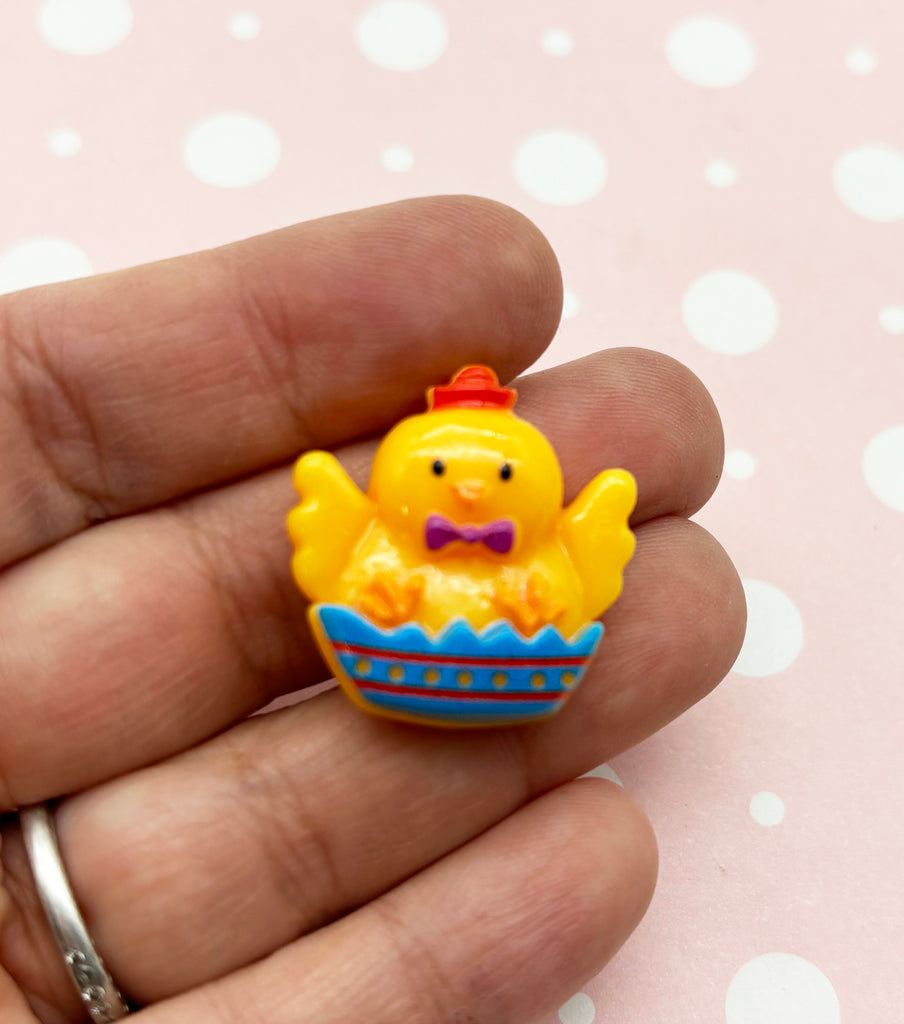 a small yellow rubber ducky sitting in a blue boat