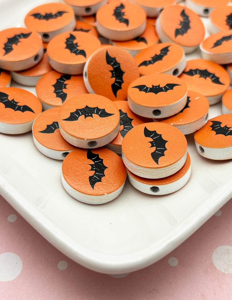 a white plate topped with lots of orange and black buttons