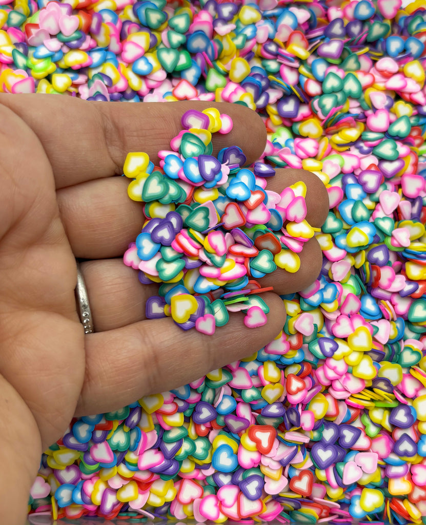 a hand holding a bunch of colorful beads