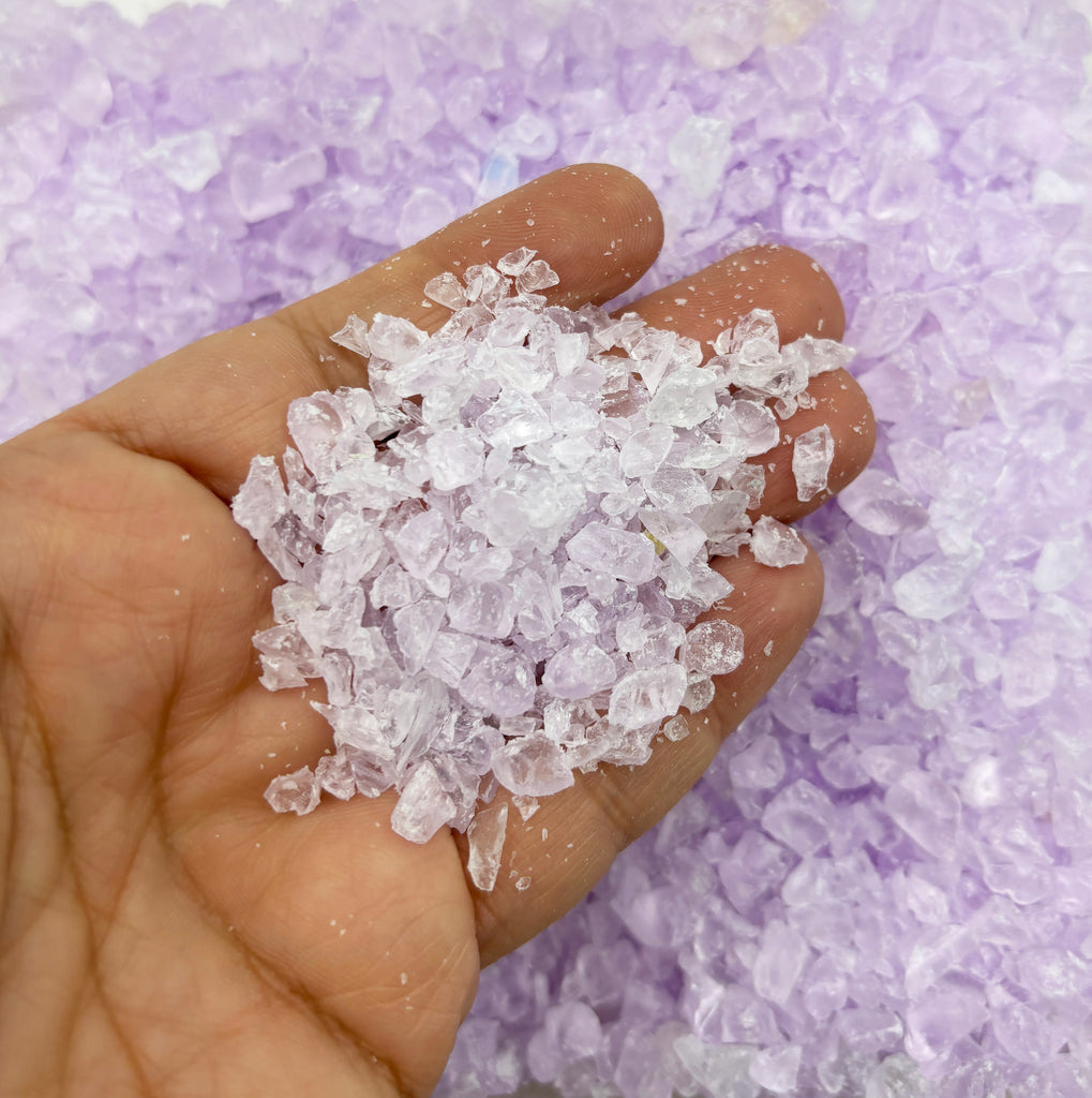 a hand holding a handful of sugar crystals