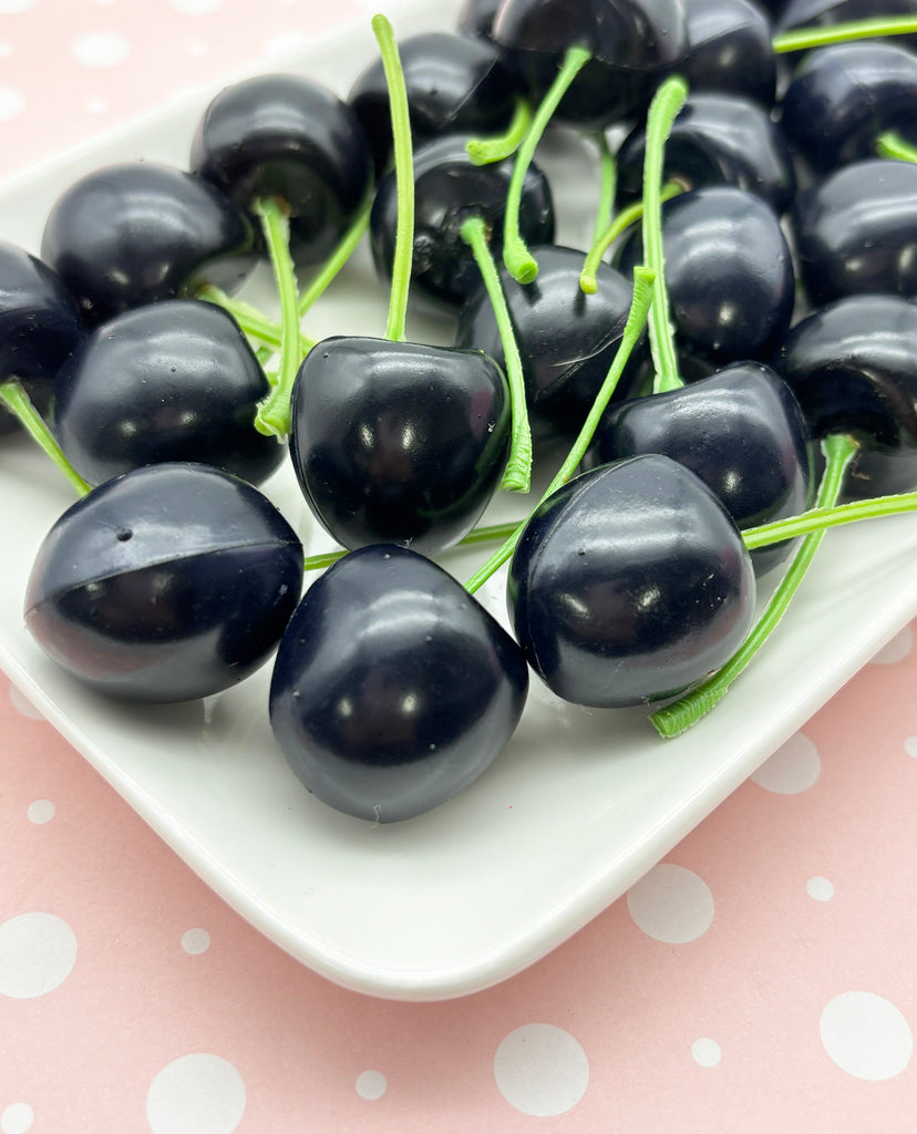 a close up of a plate of cherries on a table