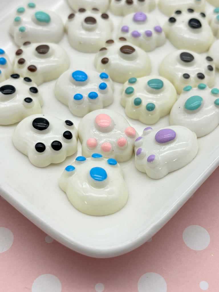 a white plate topped with lots of white and blue cookies