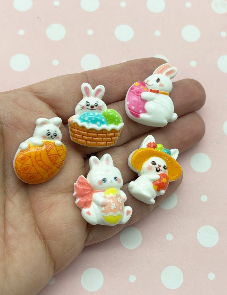 a hand holding a bunch of small toy animals