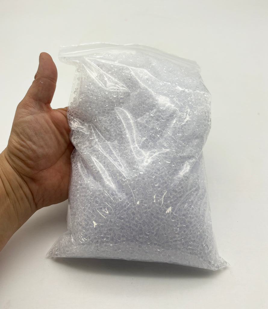 a hand holding a plastic bag with a white background