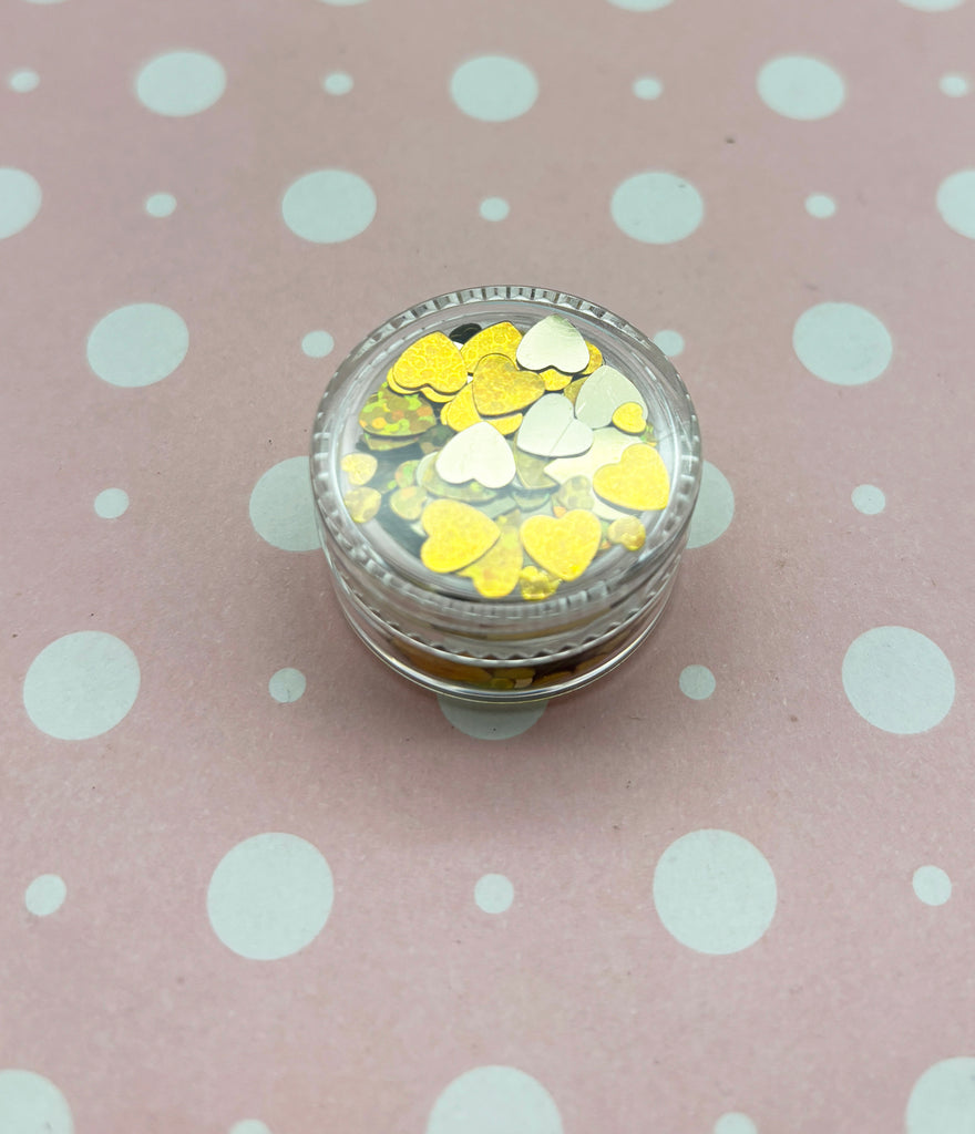 a glass jar with yellow and white confetti in it