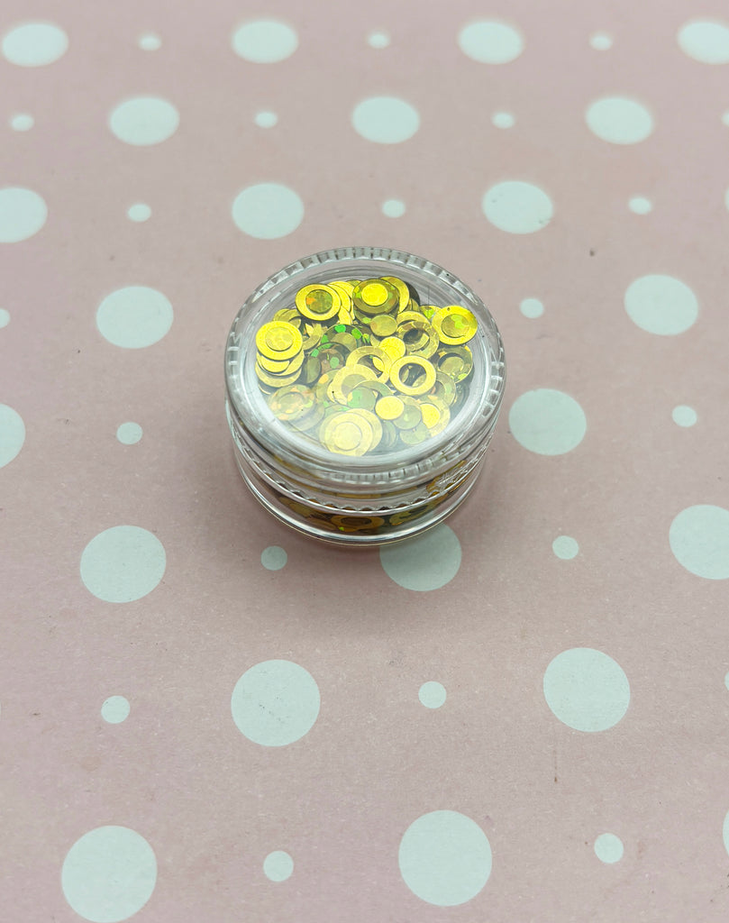 a small jar of yellow and white polka dots