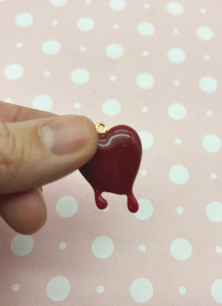 a person holding a tiny heart shaped object