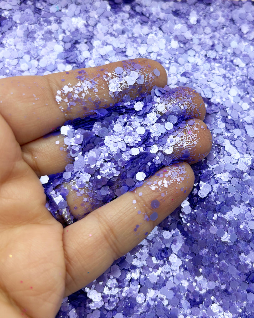 a hand holding a purple and white substance