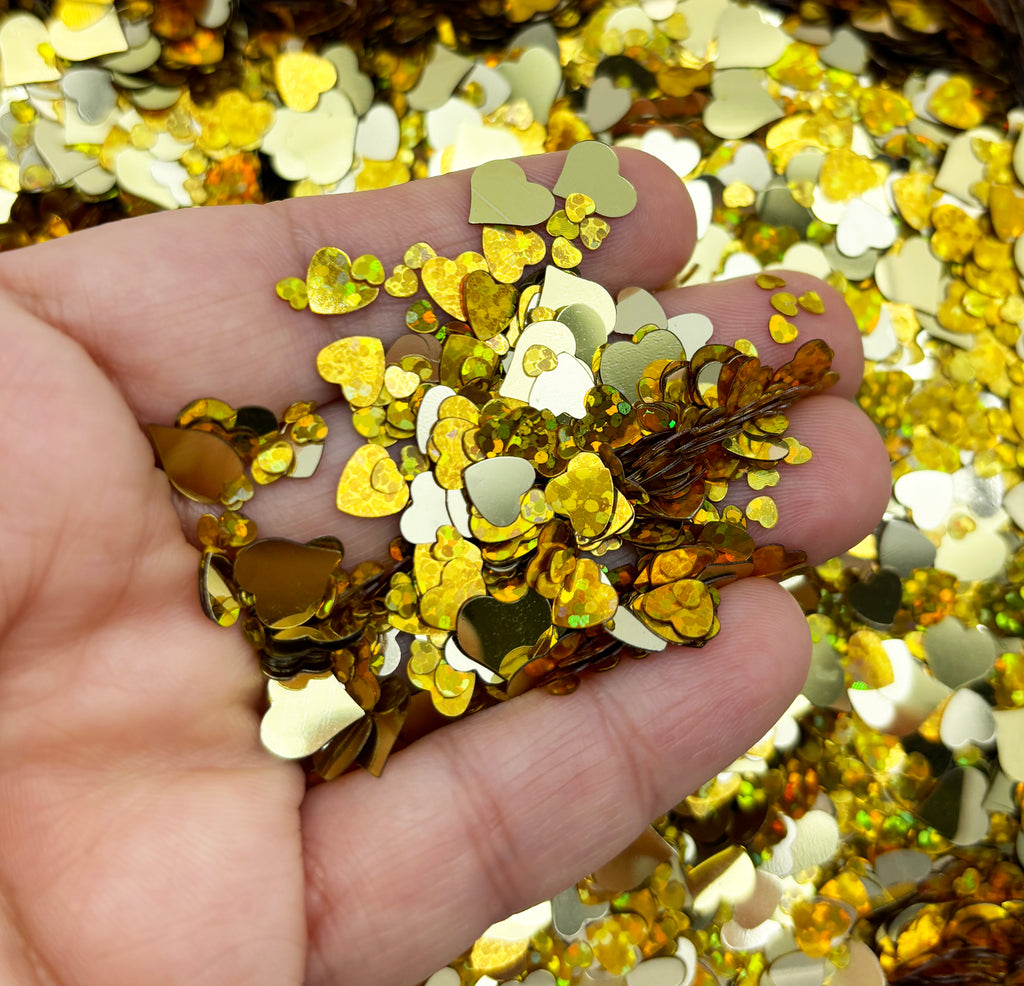a hand holding a handful of gold flakes